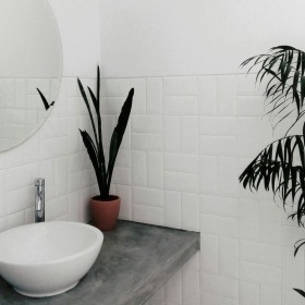 a bathroom with a round mirror